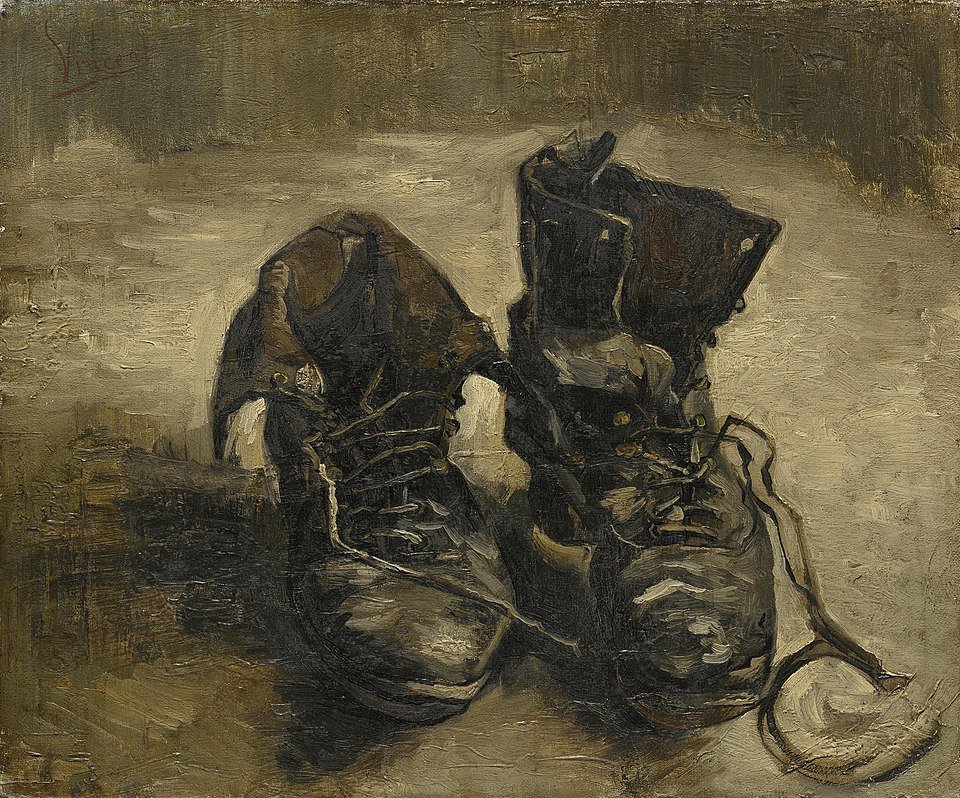 An oil painting by Vincent van Gogh titled "A Pair of Shoes," depicting two worn, dark-brown leather boots with laces, set against a muted, earthy background.